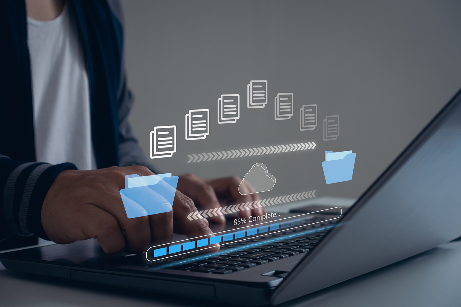 Person using a laptop with illustrated file transfers and a progress bar