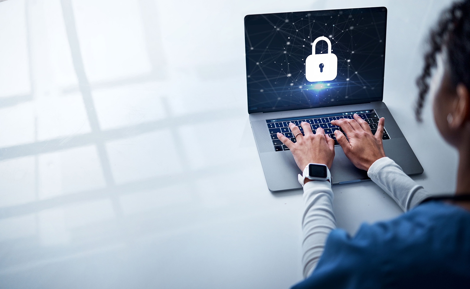 Person using a laptop displaying a padlock symbol