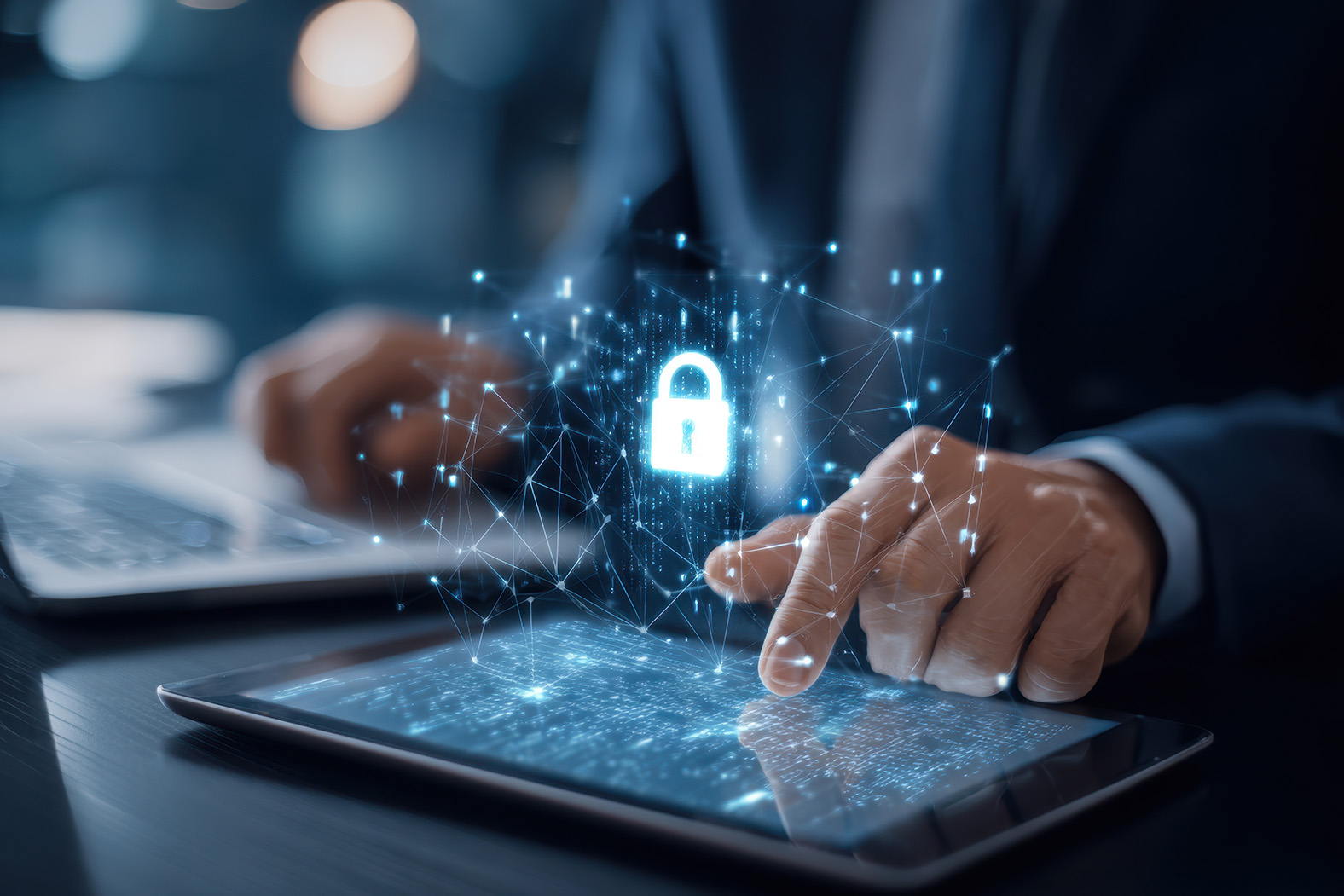 Person using a tablet beside a laptop with a padlock security illustration