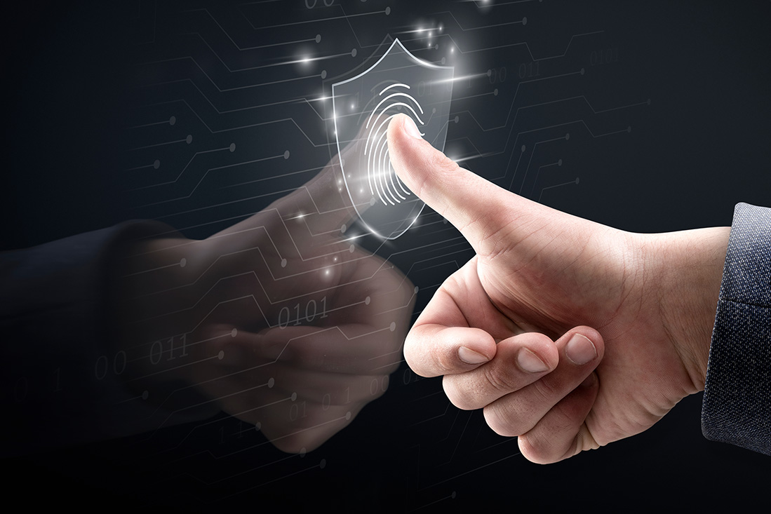 Thumb touching a digital fingerprint icon inside a shield