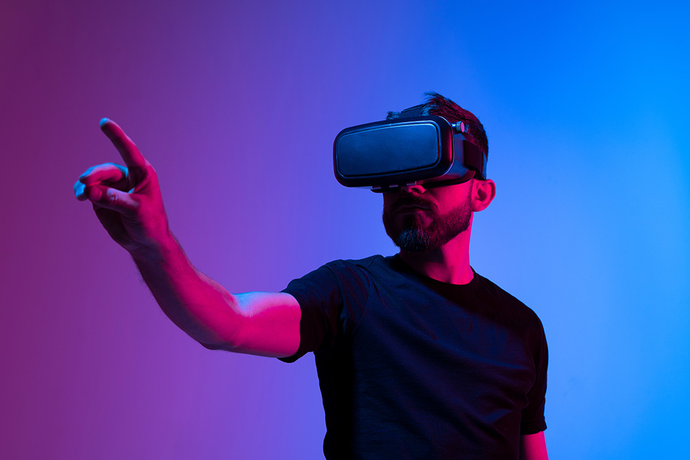 Person wearing a virtual reality headset and pointing forward