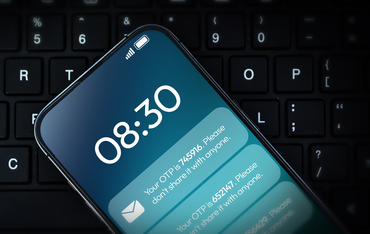 Smartphone displaying verification-code notifications on a keyboard