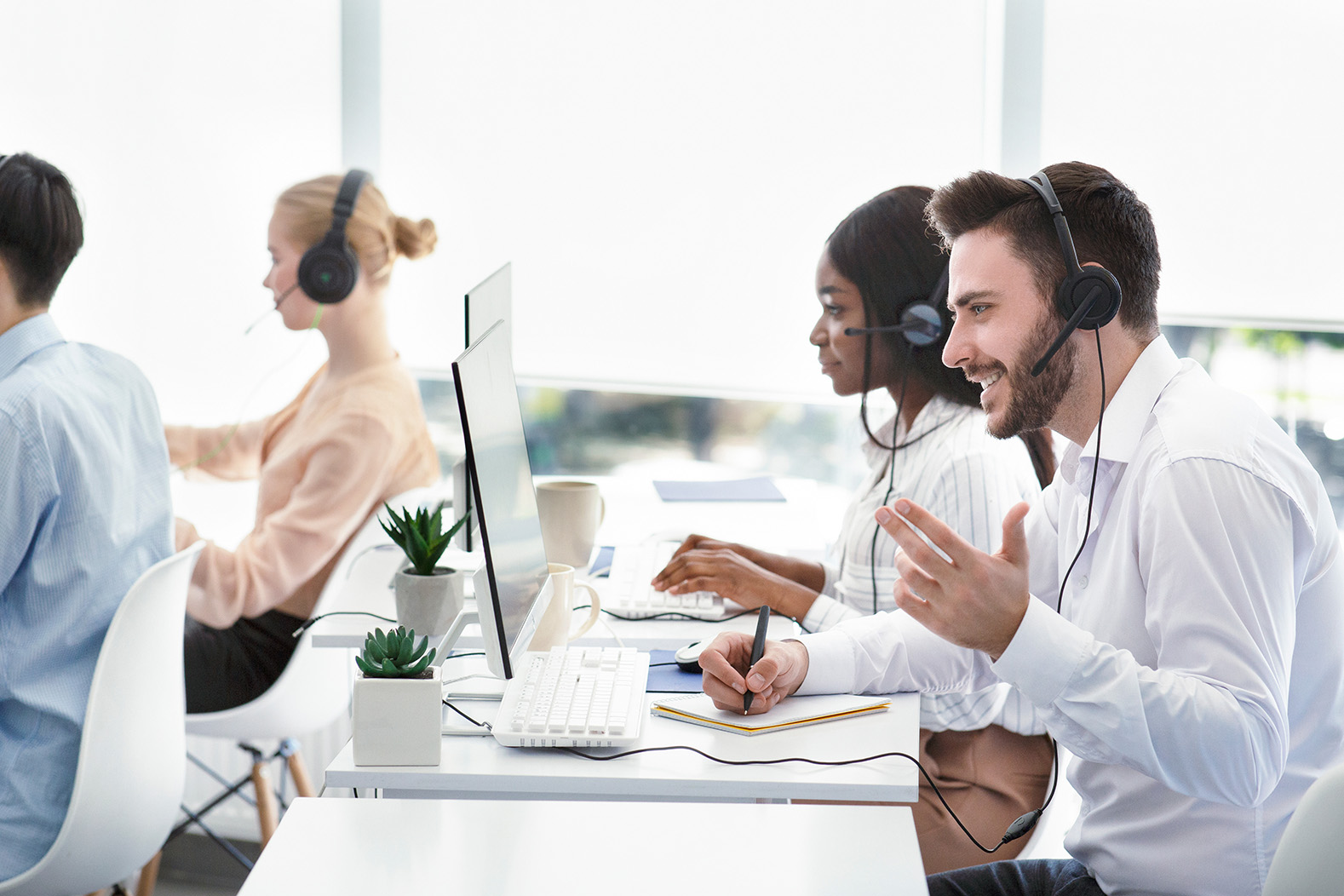 Team members using headsets at computers to handle calls