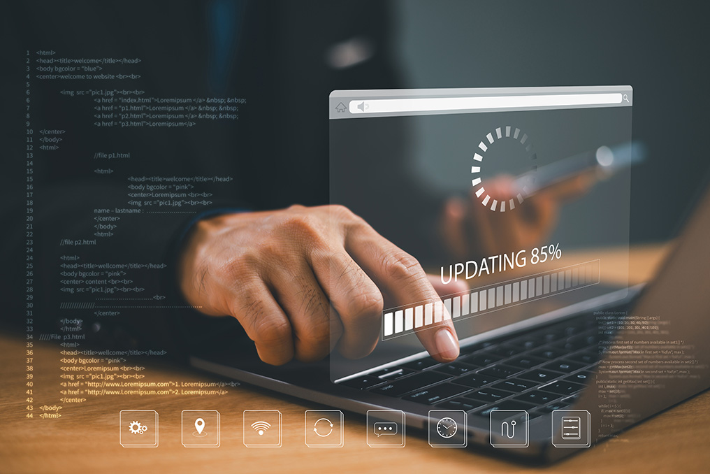 Person using a laptop with an update progress graphic