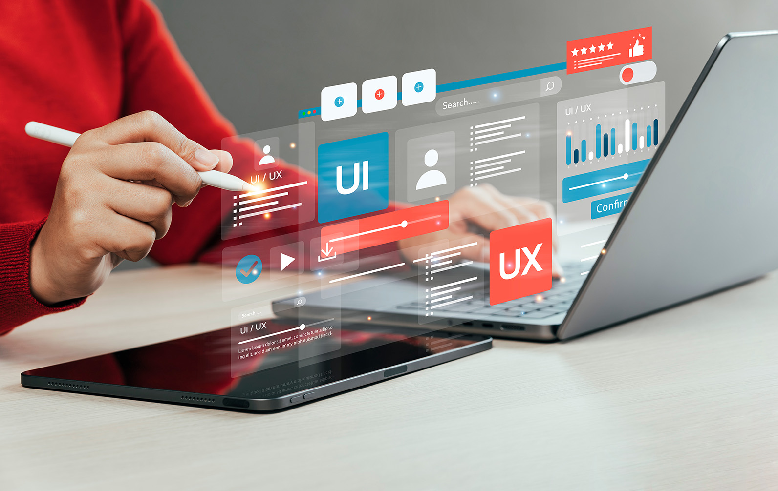 Person using a stylus and tablet beside a laptop with illustrated UI and UX graphics